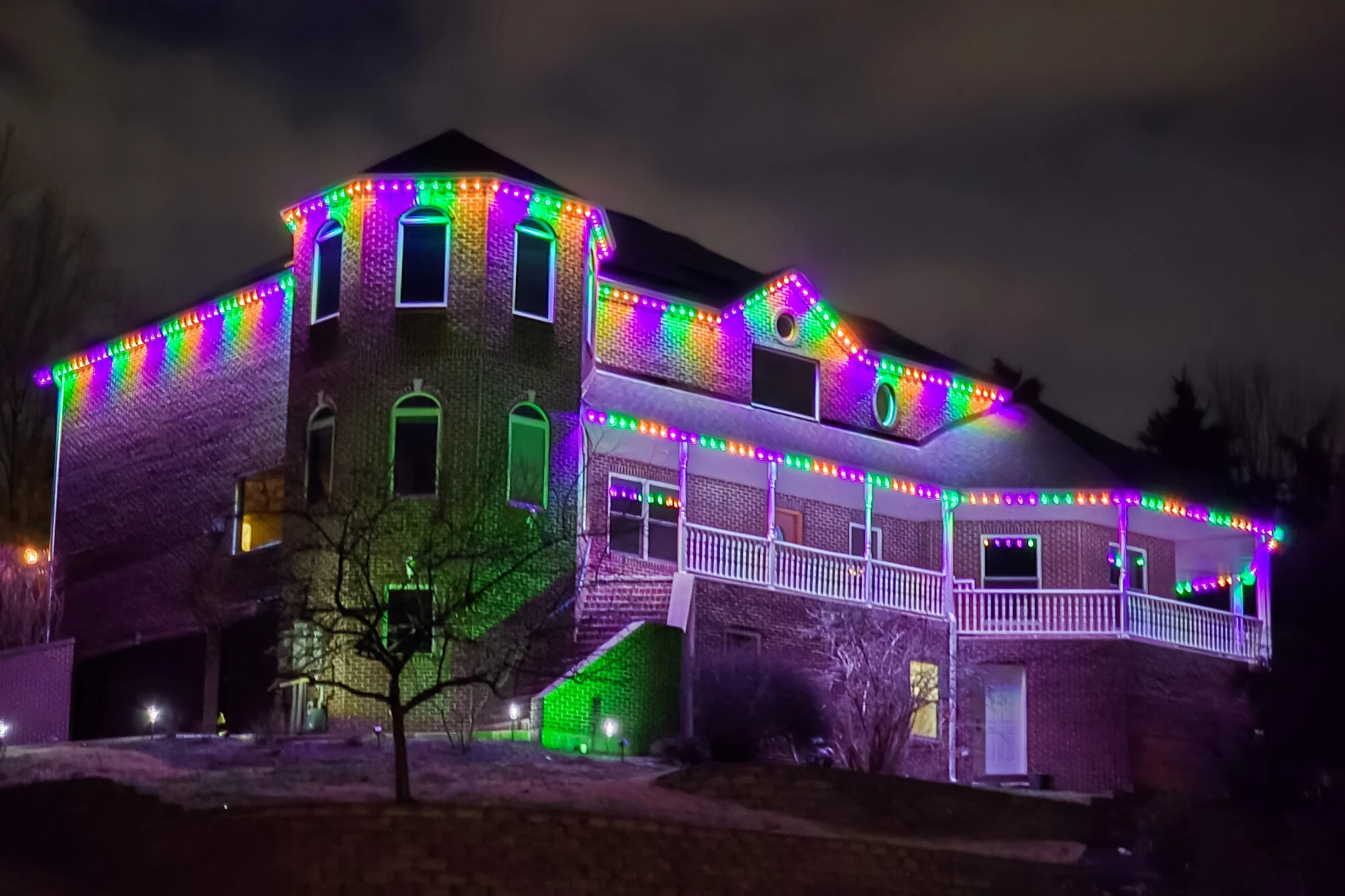 House with permanent LED lighting in purple, green, and orange lights for Halloween decor