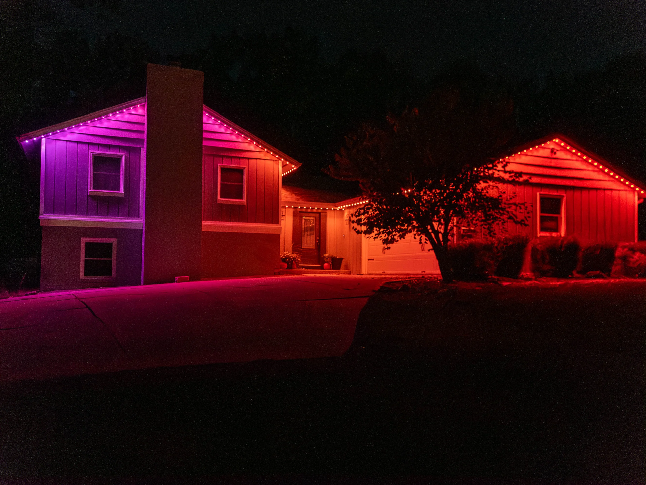House with fall lights - Red, orange, and purple.